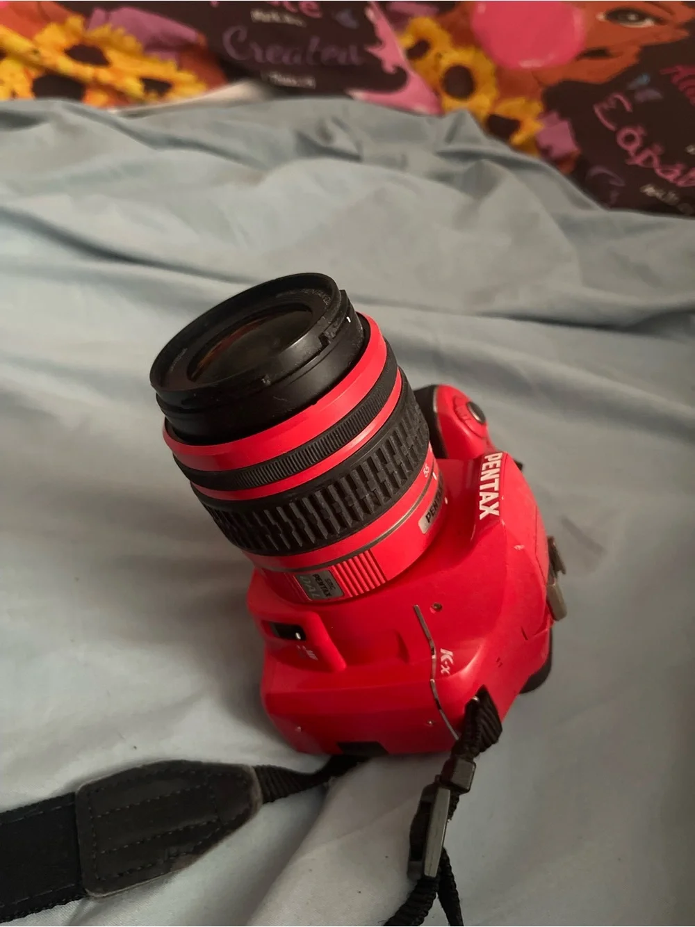 Pentax Red DSLR with Black Strap and 18-55mm Lens